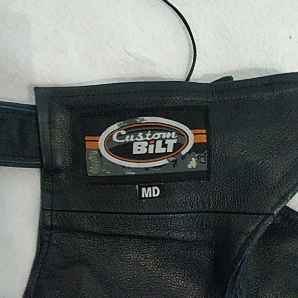 Bilt. Black  leather chaps. Zipper on out side of leg.  MD